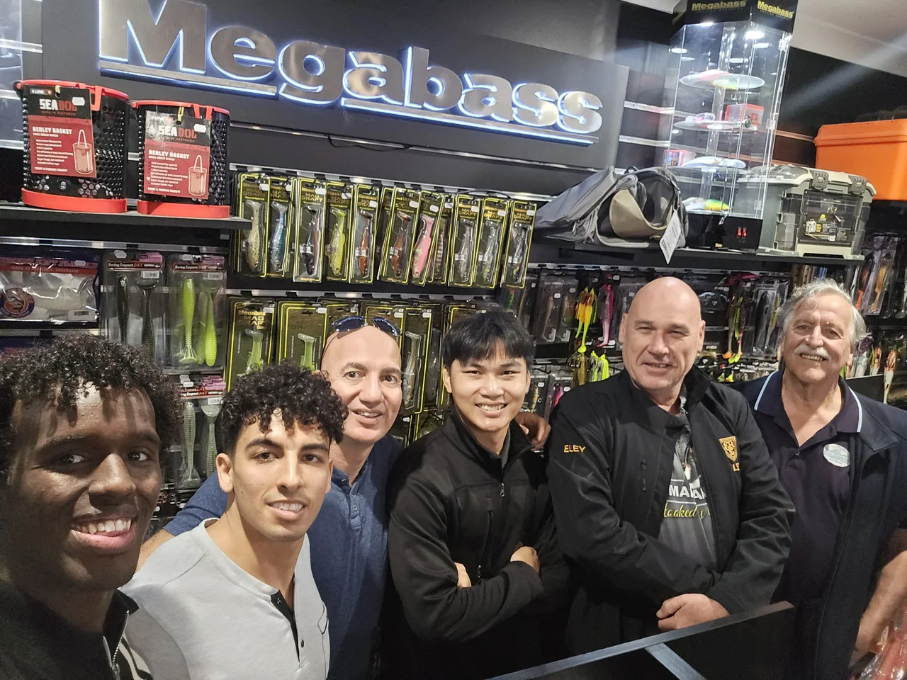 A group selfie during a visit to a fishing shop