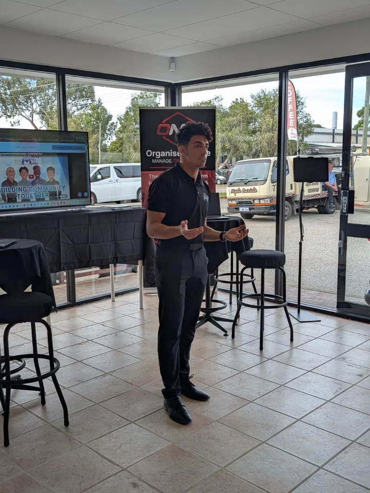 A Build My Idea speaker standing and presenting at a community event