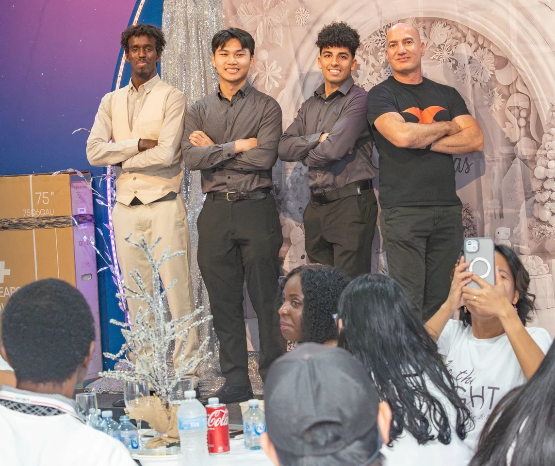 Four team members standing together at the SaladMaster celebration